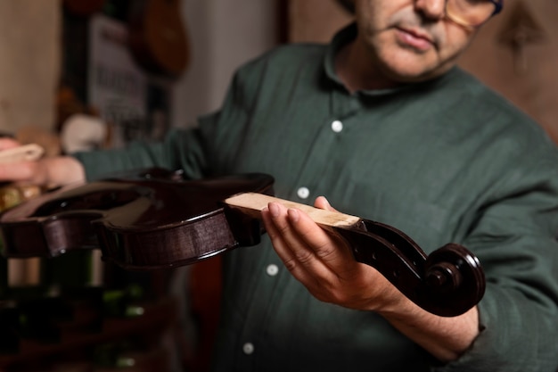 Man making instruments in his workshop alone