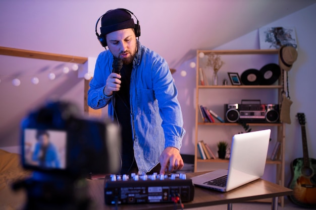 Free photo man making music in bedroom medium shot