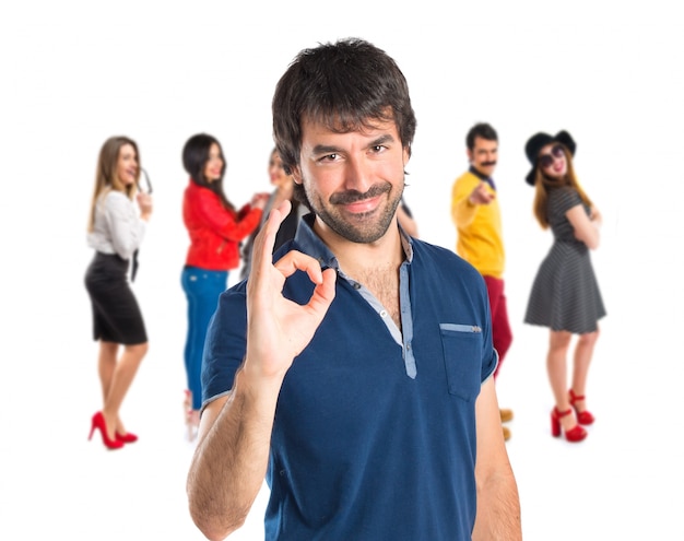 Man making Ok sign over white background