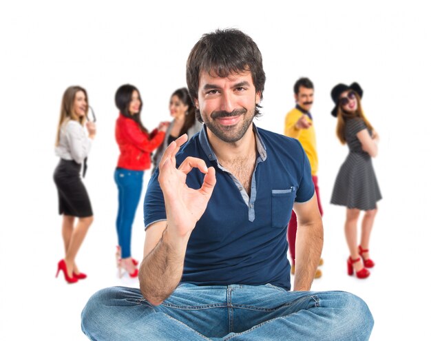 Man making Ok sign over white background