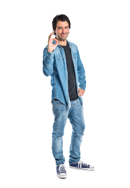 Man making Ok sign over white background