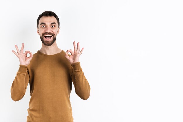 Man making okay sign with both hands and smiling