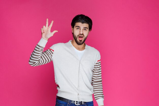 Man making peace and friendship hand sign. 