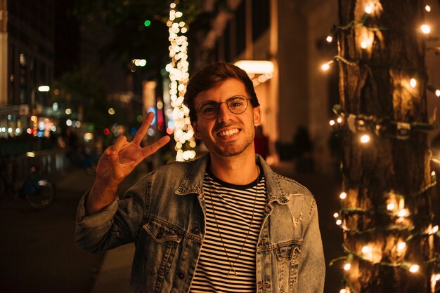 Man making peace sign and smile
