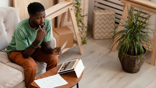 Man making a plan to redecorate house using tablet