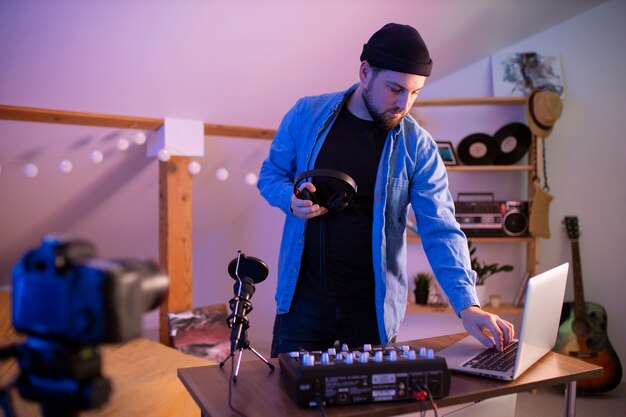 Man making pop music in bedroom front view