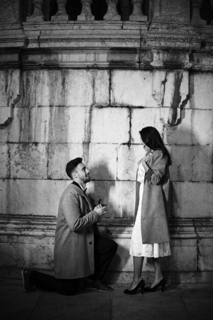 Man making proposal to woman in street 