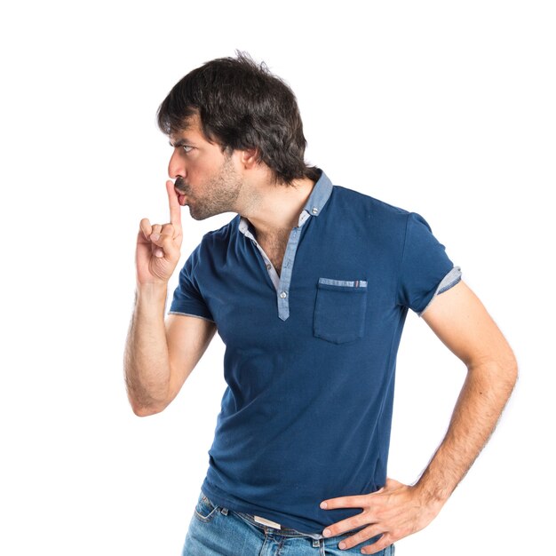 Man making silence gesture over isolated white background