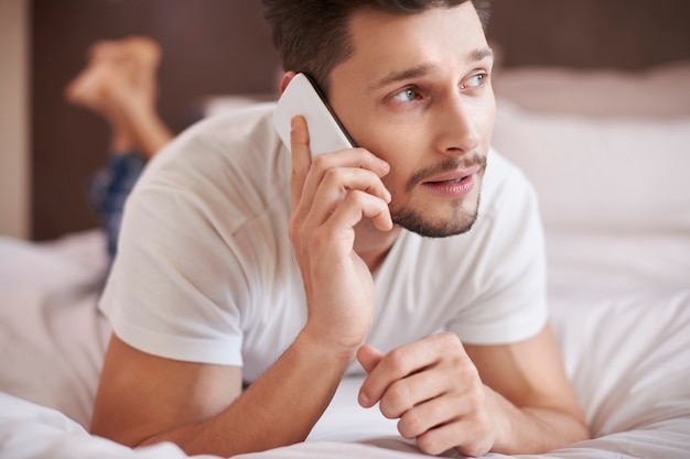 Man making some important calls after waking up