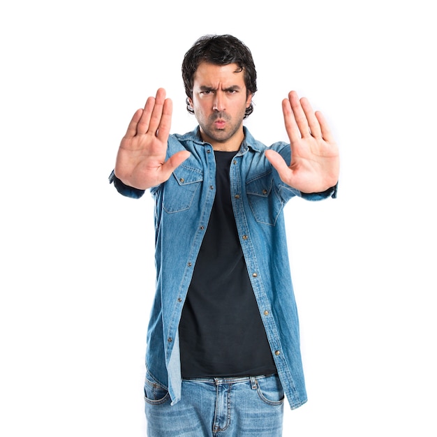 Man making stop sign over white background