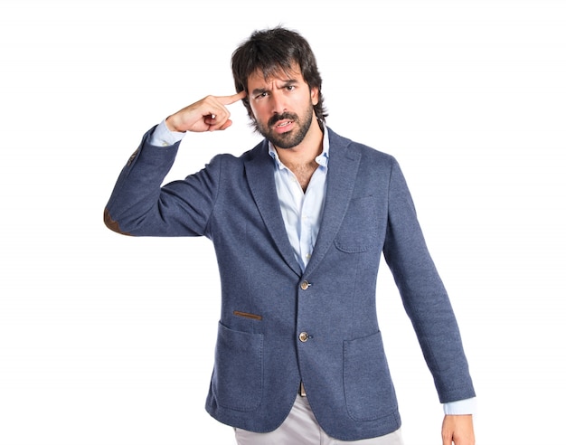 Man making suicide gesture over white background