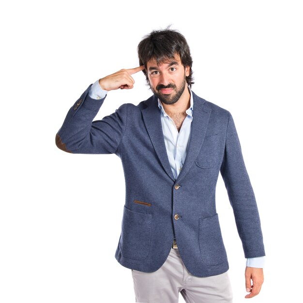 Man making suicide gesture over white background