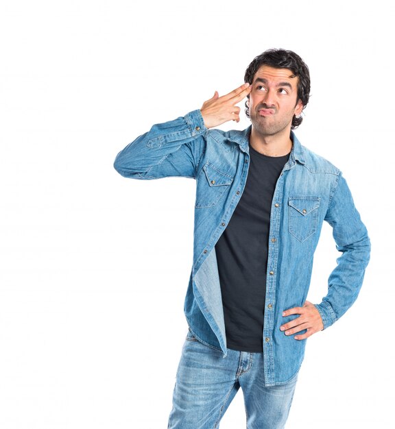 Man making suicide gesture over white background