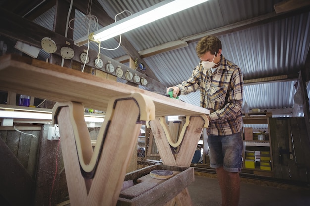 Man making surfboard