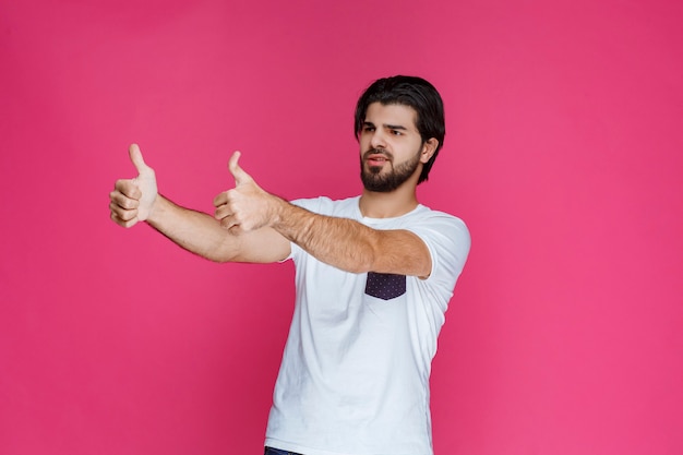 Man making thumb up sign. 