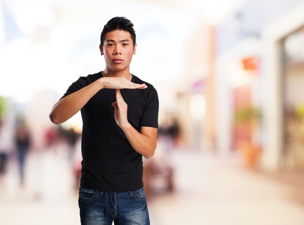 Man making a "time" gesture with his hands