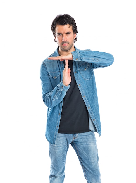 Man making time out gesture over white background