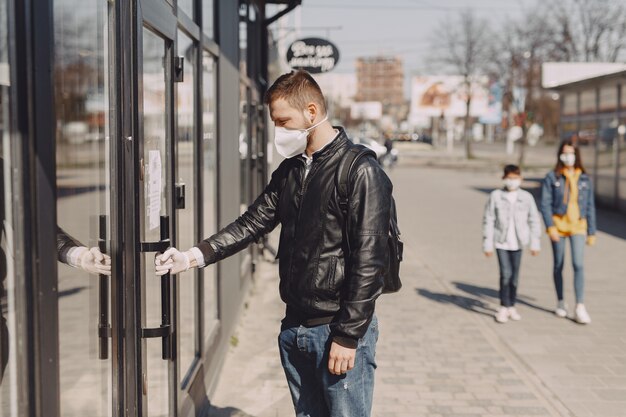 Man in a mask standing on the street