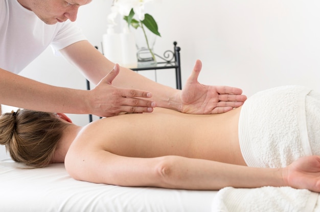 Free photo man massaging woman's back