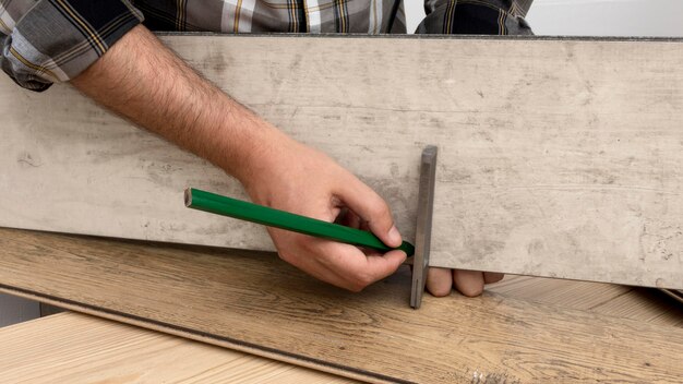 Man measuring carpentry workshop concept