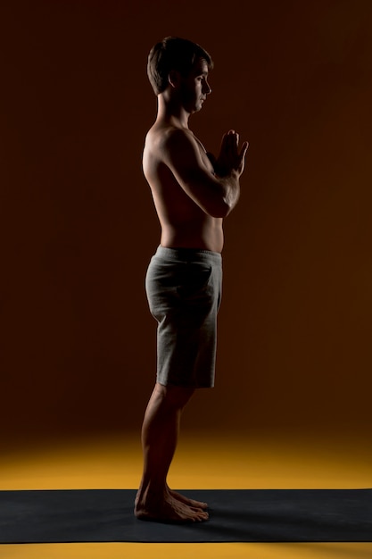 Man meditating on yoga mat