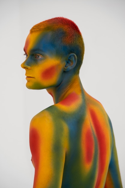 Man model posing with colorful body painting