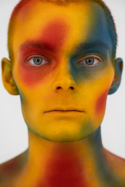 Man model posing with colorful body painting