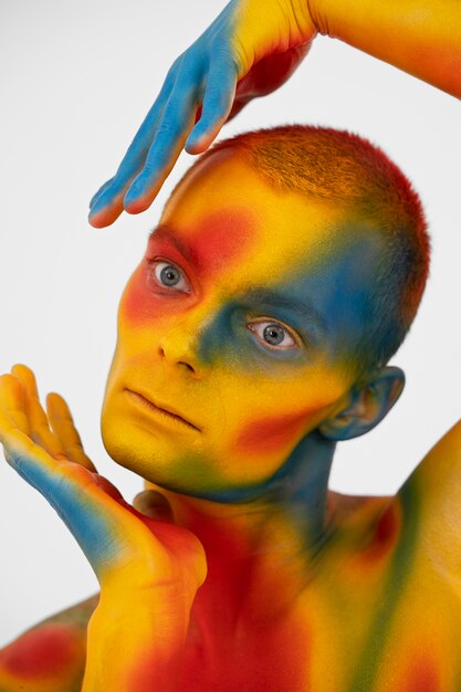 Man model posing with colorful body painting