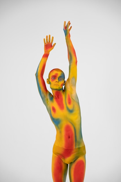 Man model posing with colorful body painting