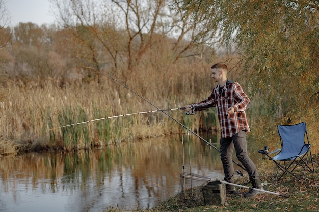 Free photo man near river in a fishing morning