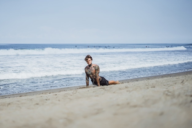 a man on the ocean coast is engaged in sports, doing gymnastics