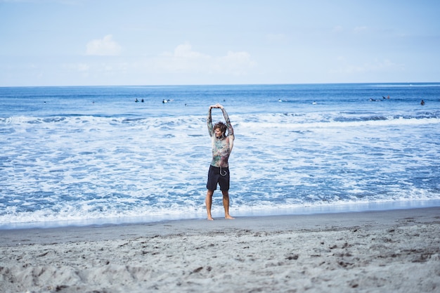 a man on the ocean coast running along the seashore