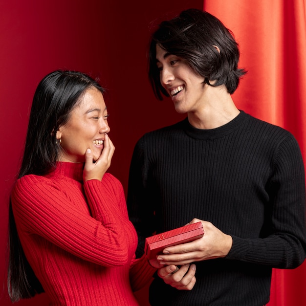 Free photo man offering gift to woman for chinese new year