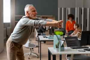 Free photo man at the office stretching during a work day