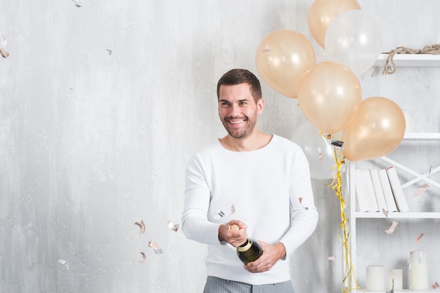Man opening bottle of champagne