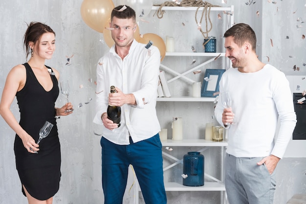 Man opening champagne bottle