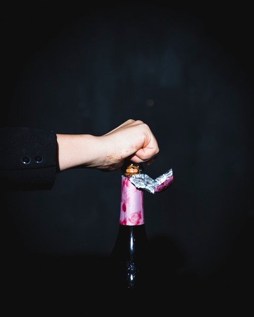 Man opening festive bottle of champagne