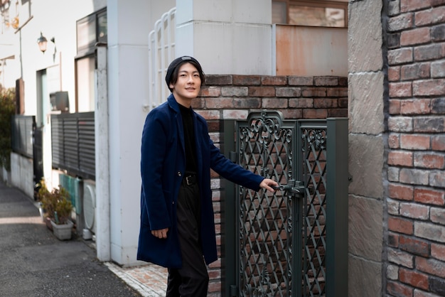 Man outdoors opening a gate