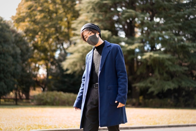 Man outdoors in the park with face mask