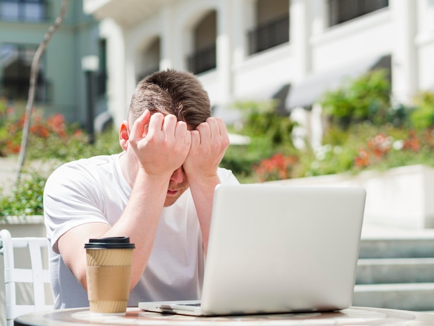 Man outdoors working on laptop