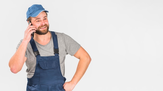 Man in overall talking by phone 