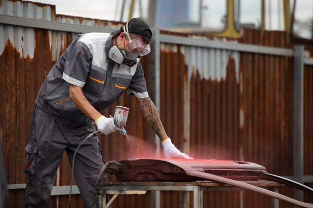 Man painting car door side view