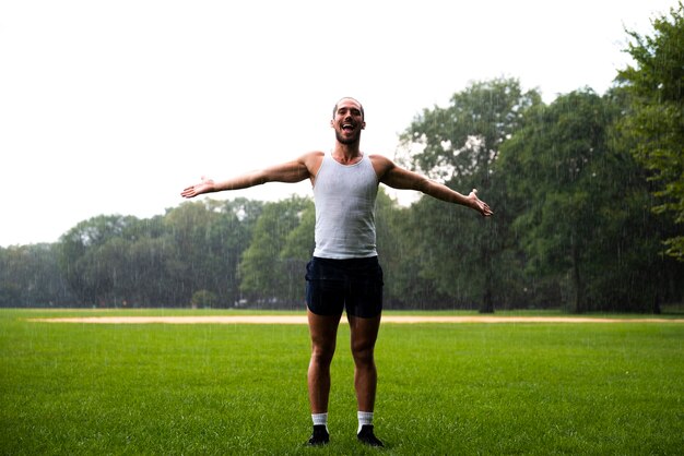 Man in park with arms wide open