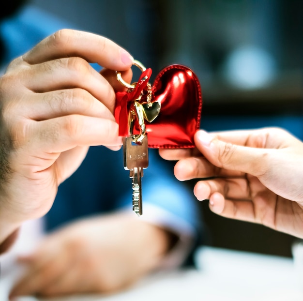 Free photo man passing house key as a gift