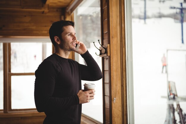 Man on the phone in front of window