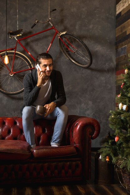 Man phoning on couch at christmas