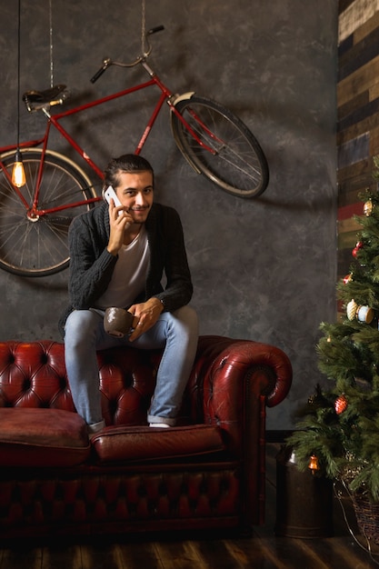 Man phoning on couch at christmas