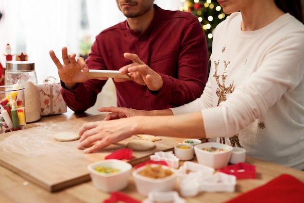 Man photographing Christmas cookies in the kitchen