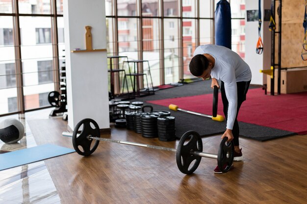 Man placing weight plates on bar