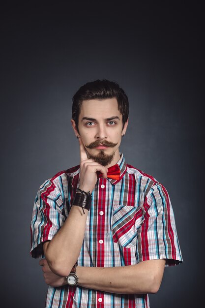 Man in plaid shirt and bow tie in the studio